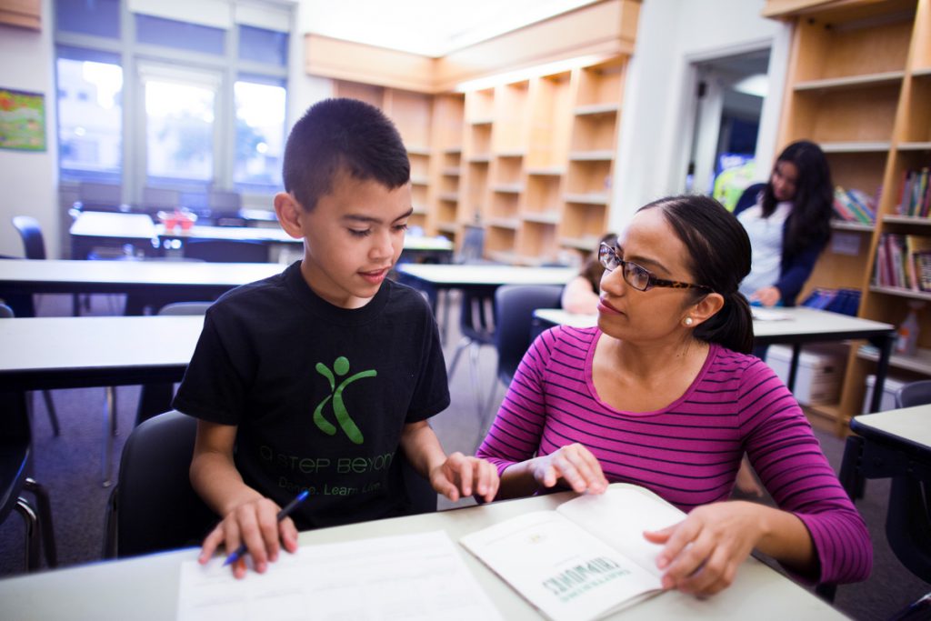 Woman tutoring young boy